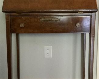 Antique DropFront Ladies Desk with Single Drawer below Writing Surface and Raised on Square Taped Legs.  Interior has Pigeon Holes and Drawer.Desk Surface is 29”H.  Overall (27”W x 14 1/2”D x 40”H. Top of Desk is 7”D
