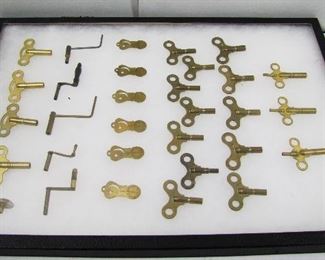 Lot 119   Lg. Riker Case full of 24 Brass Clock Keys. Includes numbered set (different sizes) plus some clock keys with speed adjust ends and 6-1890 patented “Crescent” hard Brass pocket watch opening blades. Cond: no damage found.   $60 - $100