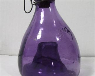 Lot 158   1900 French Amethyst Glass Fly Trap Bottle. Has Orig. Cork & Wire Handle, 6”high. Cond: Minor wear, cork is abraded.   $75 - $100