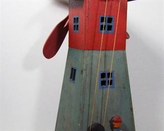 Lot 174   1930s Hand-made Folk Art Windmill Garden Ornament with Mechanical action. 4 rotating blades turn by a hand carved figure using pullies and string. 11” X 18” X 28”h. Cond: The 4 wood blades were replaced & paint matched. Sm. pc. missing from figures hat. Orig. paint shows patina.   $100 - $175