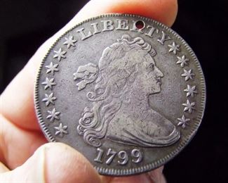 Lot 187   1799 Draped Bust Silver Dollar, Normal Date Stamped, 7x6 Stars Obverse with Berries.  Coin has a 1mm hole punched at top on the letter “R” on date side. Cond: Overall condition is in the VF range.   $500 - $1500