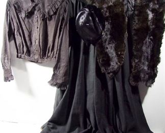 Lot 238   C/1890 4 Pc. Victorian Ladies Clothing Lot. Includes Black Pleated Waist-shirt, Full Black Wool Skirt,1910 Black Mink Stoll & Black Velvet trimmed Hat. Cond: Pleated Waist-shirt shows wear from use. The skirt shows heavy wear around the button closure. Fur Stoll shows some moderate wear & no damage to the hat.   $75 - $150