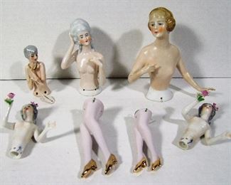 Lot 276   C/1920’s German porcelain half doll group includes Heidi type, 3 Marie Antoinette types including 2 holding roses, Flapper type with silver hair and 2 pair of legs with gold shoes. 3 with original J.L. Hudson’s string tags, tallest 5” h.  Cond: Tallest has ½” dia. chip at base, Flapper missing tip of thumb.  $75 - $150