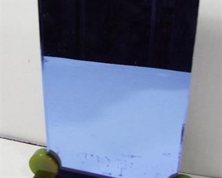 Lot 278   1930 Art Deco small blue glass vanity mirror with green & black Bakelite base, 6 ½” X 9”h. Cond: No Damage found.  $40 - $60