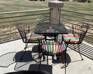 Wire metal patio table H29" x W28" x D28". Four (4) chairs with multi-colored cushions H32" x W24" x D19". No manufacturer found. Good used condition.