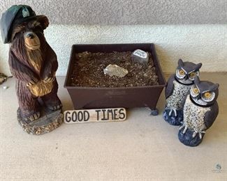 Wood carved bear with Army beret H31" x 12" diameter base. Wood carved sign "GOOD TIMES" Two (2) plastic owls with moveable heads (rocks in base for weight) H18" x 6" diameter. Plastic flower planter on casters H11" x W24" x D20" (filled with dirt - heavy).