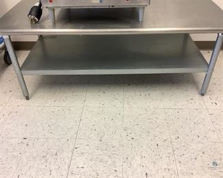 Eagle Mfg. metal 2-tier table, H 23.5x W 60"x D 30", used condition.