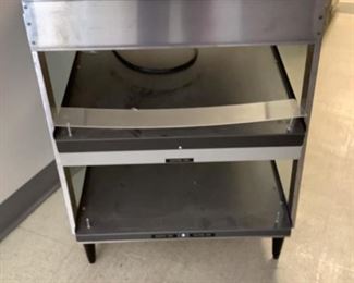 One stainless steel 2-shelf warming table, Model# CRSOS-24D, SN# 6417209504, H 33"x W 24"x D 25".