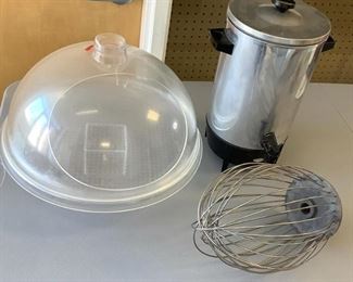 One clear plastic pedestal cold food server with dome lid, H 13"x W 15.5". One West Bend Coffee server that holds 30 cups, no electrical cord, unknown working condition. One commercial grade metal whisk, H 13.5"x W8", used condition.