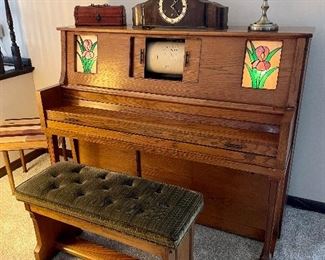 Vintage player piano with music rolls included