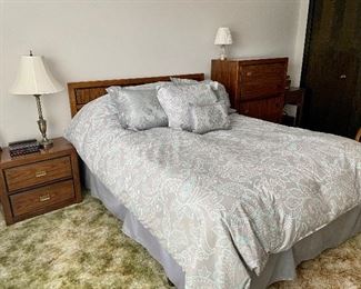 Vintage wood bedroom Set includes: tallboy dresser, one nightstand, queen bed, headboard and mattress including covers and pillows, and nine drawer low dresser with mirror