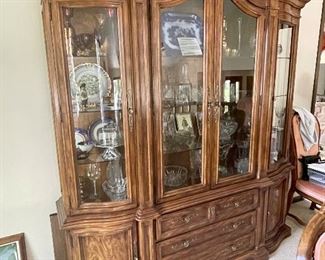 Wood curio cabinet with adjustable glass shelves, interior lighting and lower cabinet storage. Part of a matching set with wood expandable sideboard and wood dining table with two leaves and eight chairs