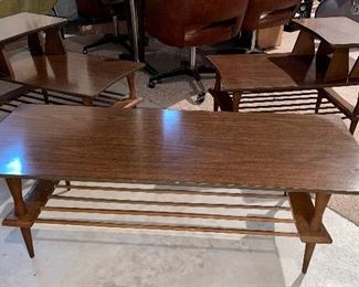 Set of three mid century modern wood tables, one coffee table and two end tables in excellent condition.