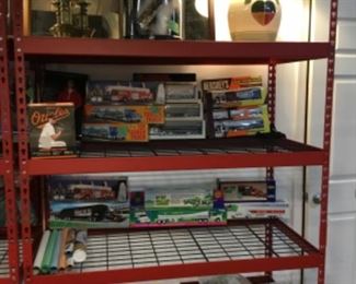 Shelves full of home goods/decor, toy trucks, Barbies