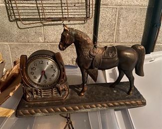 Is this horse more puzzled by the concept of time or the tiny horses at his feet?