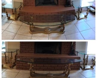 1970s set of glass top tables with gold leaf ornate pillar bases. Oval table measures 5ft 4in long, 1ft 10in wide, and 1ft 4 in tall. Each end table measures 2ft 3-3/4in long, 1ft 11-1/8in wide, and 1ft 9in tall. Purchased in 1976. One owner. Asking price $1,400.00.