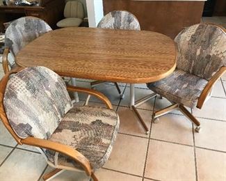 2005 Kitchen table and four swivel arm chairs. Arm chairs are on castors. Table pictured with leaf insert. With insert, table measures 5ft long, 3-1/2ft wide, 2-1/2ft tall. Leaf insert measures 1-1/2ft long by 3-1/2ft wide. Originally purchased in Hawaii. Three owners. Asking $150.