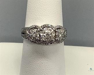 One stamped 10kt white gold custom wax and cast ring with a comfort shank with a rhodium plated finish. Twenty-seven shared prong set round brilliant cut diamonds, approximate weight all stones, 0.20ct. 3.50gtw, size 7. Appraisal certificate included.