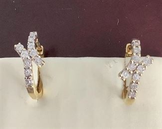 One pair stamped 10kt yellow gold lady's hoop style earrings with hinged clip backs. 0.05ct, 1.87gtw. Appraisal certificate included.