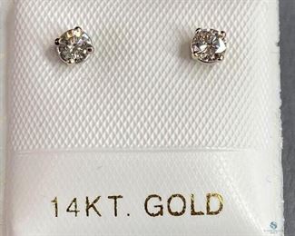 One stamped 14kt white gold cast stud earrings with friction posts with a rhodium plated finish. Two basket set round brilliant cut diamonds, 0.42gtw. Appraisal report included