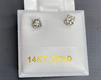 One pair stamped 14kt white gold cast stud earrings with friction posts with a rhodium plated finish. Two basket set round brilliant cut diamonds, 3.17x1.6mm, 0.43gtw, with appraisal certificate included.