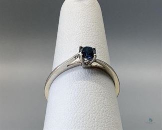 One stamped 10kt white gold combination cast and assembled solitaire ring with a bypass shank with a rhodium plated finish. One prong set round brilliant cut treated diamond, 4.40x2.63mm, size 6.25, 1.21gtw, with appraisal certificate.