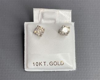 One pair stamped 14kt white gold cast stud earrings with friction posts with a rhodium plated finish. Two basket set round brilliant cut diamonds, 4.60x3.21mm, with appraisal certificate, 0.78gtw.