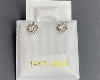 One pair stamped 14kt white gold cast stud earrings with friction posts with rhodium plated finish. Two basket set round brilliant cut diamonds, measuring 3.90x2.49mm, 0.52gtw. Appraisal certificate included.
