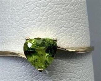 Size 6 stamped 10kt yellow gold, cast and assembled ring with a bypass shank with a high polish finish. One prong set heart cut natural peridot, 4.45x4.80x3.11mm, with appraisal certificate, 0.92gtw.