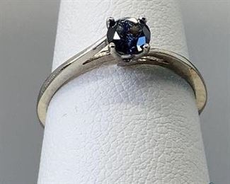 One stamped 10kt white gold combination cast and assembled solitaire ring with a bypass shank with a rhodium plated finish. One prong set round brilliant cut treated diamond, measuring 4.53 x 2.74mm, size 6.5, 1.18gtw, with appraisal certificate included.