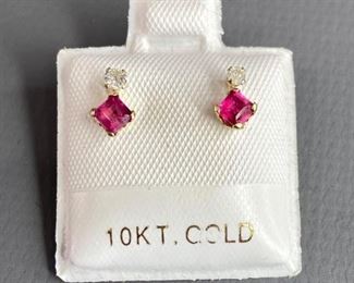 One pair stamped 10kt yellow gold hand assembled stud earrings with friction posts. Two basket set square cut natural rubies, 2.95x2.94x1.97mm, and two basket set round brilliant cut diamonds, 0.06ct, 0.42gtw. Appraisal certificate included.