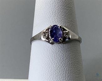 One stamped 10kt white gold custom wax and cast ring with a split shank with a rhodium plated finish. One prong set oval cut natural tanzanite, 5.75x4.25x2.21mm, 1.36gtw, size 6.5. Certificate of Appraisal included.