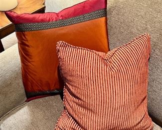 Item 59:  (2) Down Orange Pillows (rear): $75 for pair                                                                            Item 60:  (2) Down Striped Pillows (stripes - front): $75 for pair