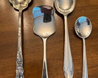 Item 116:  Sterling Pierced Spoon (left):  $24                                                                Item 117:  Flat Edge Serving Spoon (2rd from left):  $12                                                                                                                         Item 118:  Sterling Serving Spoon (3rd from left):  $28                                            Item 119:  Sugar Spoon (right):  $12