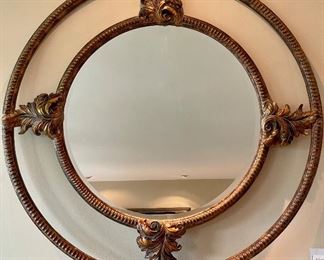 $150; Circular mirror with leaf embellishments and gold highlights; 47” diameter