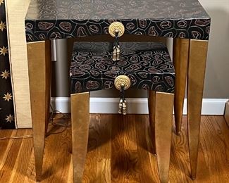 (2pc) NESTING SIDE TABLES | Carved reptilian style black color wood top, gold painted tapered legs, gilt accent with tassel; large table h. 26-1/4 x 25 x 14 in., small table h. 20-1/4 x 14-1/4 x 12-1/4 in.