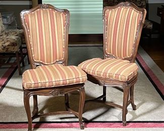 PAIR FRENCH STYLE CHAIRS | Two Rococo style side chairs with cane seats, padded upholstered seat backs and matching seat cushions in striped fabric; h. 42 x 20 x 21 in.