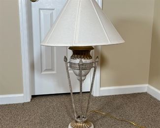 ITALIANATE TABLE LAMP | Designed as a small urn resting on four torch-form rods on a gilt base; overall h. 36 in.
