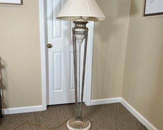 ITALIANATE FLOOR LAMP | Small urn resting on four long torch-form rods joined on a gilt scalloped base; overall h. 63 in.
