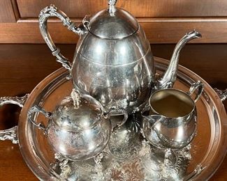 (4pc) SILVER PLATED TEA SET | A silver on copper tea set, including a teapot, covered sugar, and open creamer, all on an engraved round tray with shell-form handles (dia. 13 in.)
