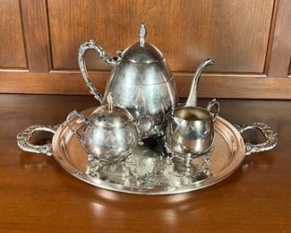 (4pc) SILVER PLATED TEA SET | A silver on copper tea set, including a teapot, covered sugar, and open creamer, all on an engraved round tray with shell-form handles (dia. 13 in.)