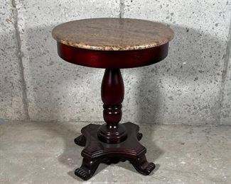 STONE PEDESTAL TABLE | Textured stone top over a turned wood pedestal and four carved feet; dia. 22 x h. 28 in.