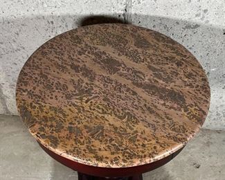 STONE PEDESTAL TABLE | Textured stone top over a turned wood pedestal and four carved feet; dia. 22 x h. 28 in.