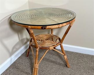RATTAN SIDE TABLE | Rattan / cane spiral side table with a round glass top and medial shelf; dia. 24 x h. 22 in.