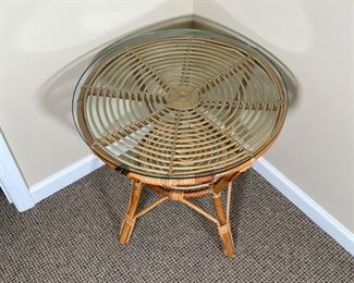 RATTAN SIDE TABLE | Rattan / cane spiral side table with a round glass top and medial shelf; dia. 24 x h. 22 in.