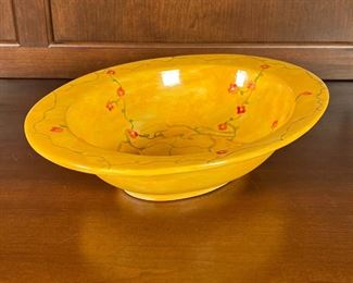 HAND PAINTED SERVING BOWL | Large ceramic bowl hand painted yellow with sprawling vines of roses, signed and dated on the bottom; l. 14 in.