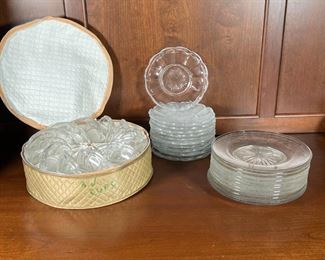 (34pc) VINTAGE GLASS PLATES | Vintage pressed glass dining pieces including: 11 salad plates with radial motif (dia. 7 in.); 11 flower-shaped bread plates; and a complete set of 12 vintage pressed glass fruit dessert cups with radial design, in an original custom quilted storage case by Seal Sac