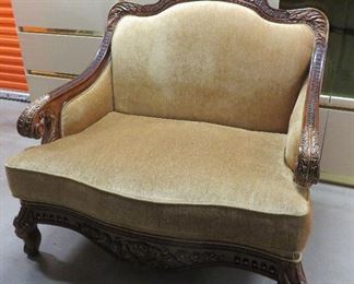 Over size chair with carved details.  51" width x 48" height at back x 39" deep