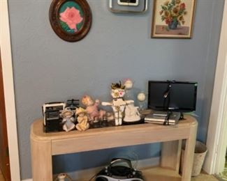 Sofa table, Saints doll, small TV