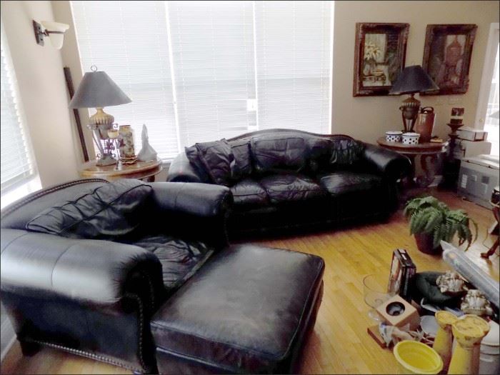 Living Room with Butter Soft Black Leather Sofa, Armchair and Ottoman. Two matching Round Side Tables with Scrolled Bases, pair of fancy Urn Lamps.
